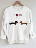 Two dog print hoodies featuring cute dachshunds with a heart balloon in a white sweatshirt design.