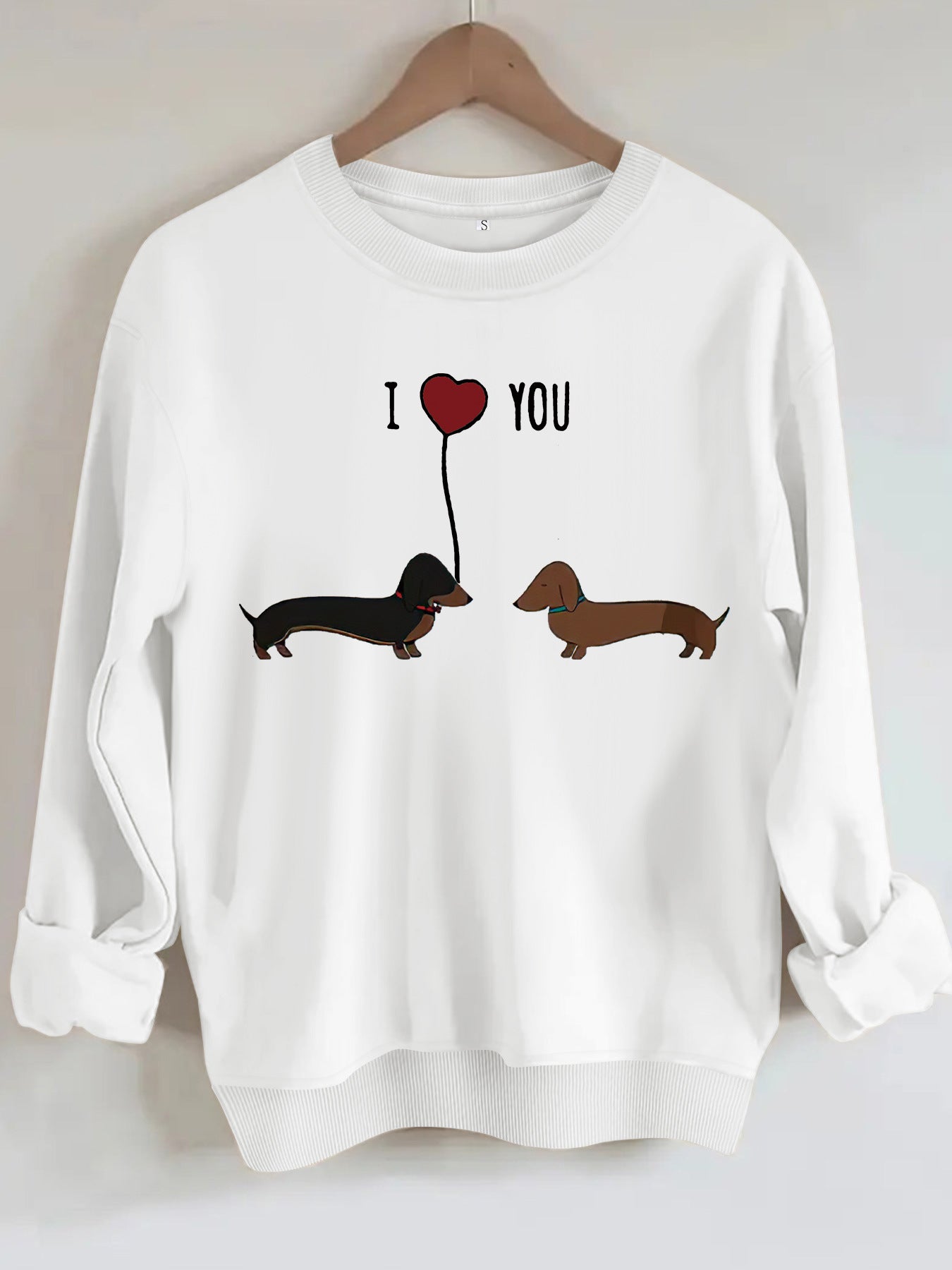 Two dog print hoodies featuring cute dachshunds with a heart balloon in a white sweatshirt design.